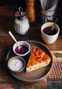 Cottage cheese pudding with cream and jam served on a plate for breakfast