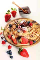 Waffle. Traditional belgian waffles with fresh fruit and powder sugar on wood