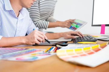 designer graphic creative creativity working together coloring using graphics tablet and a stylus...