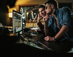 Fototapeta na wymiar Sound engineer working in a music studio