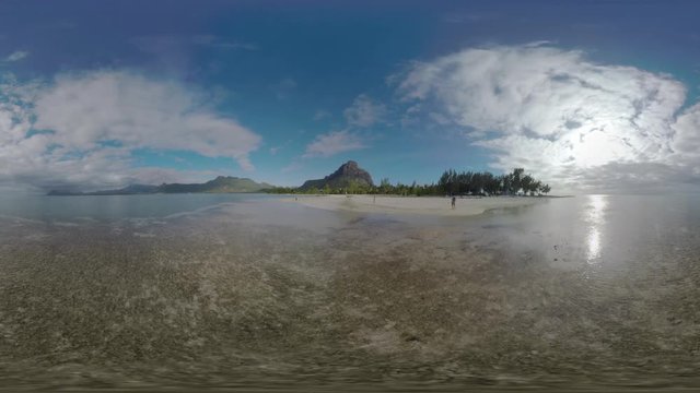 360 VR video. Landscape of Mauritius with sandy beach, ocean and mountains with Le Morne Brabant top. Family with child walking on the coast. Beautiful island nature