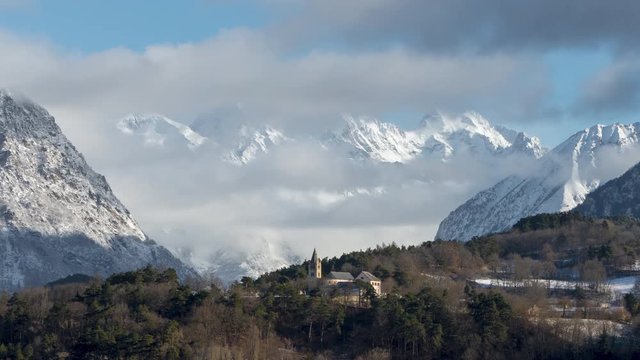 The village church of Chauffayer with moving clouds over the Olan peak in the Vaulgaudemar Valley (Time-Lapse). Ecrins National Park, Hautes-Alpes, European Alps, France