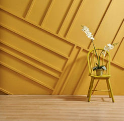 Yellow background wall with home object vase of flower computer and coffee table style.