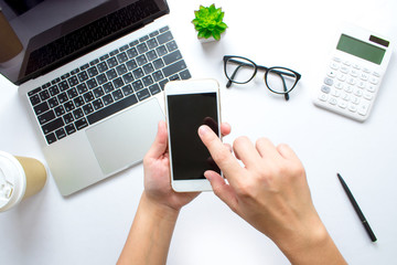 The top view of the business person is using a smartphone or social media at the desk. Close-up.
