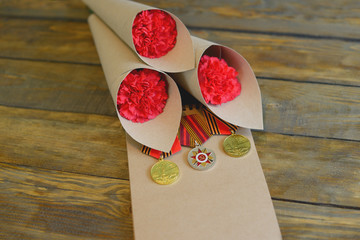 Only EDITORIAL. Moscow, Russia, may 31, 2018: red carnation and St. George ribbon on a wooden...