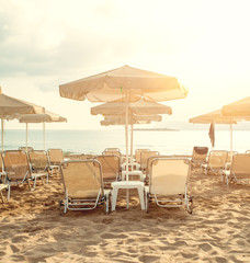 Sea beach with umbrellas and sunbeds. Summer holiday and relaxation concept