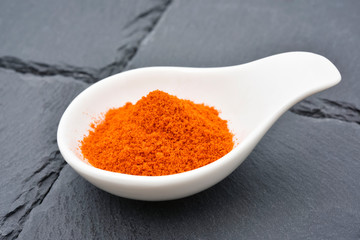 Cayenne pepper powder on a stone plate