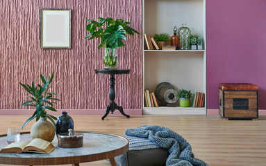 Claret red wall background, black coffee table, black chair and vase of plant. Modern bookshelf in the room.