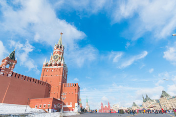 Naklejka premium MOSCOW, RUSSIA - Febuary 17, 2019: Spasskaya Tower of Moscow Kremlin and Cathedral of Vasily the Blessed (Saint Basil's Cathedral) on Red Square