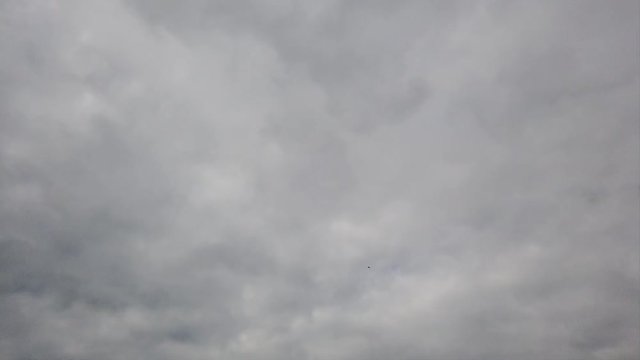 Sky timelapse with smoky dense banks of gray clouds and  evanescent effects with shadows
