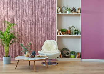 Claret red living room wall background, bookshelf, white chair and middle table style.