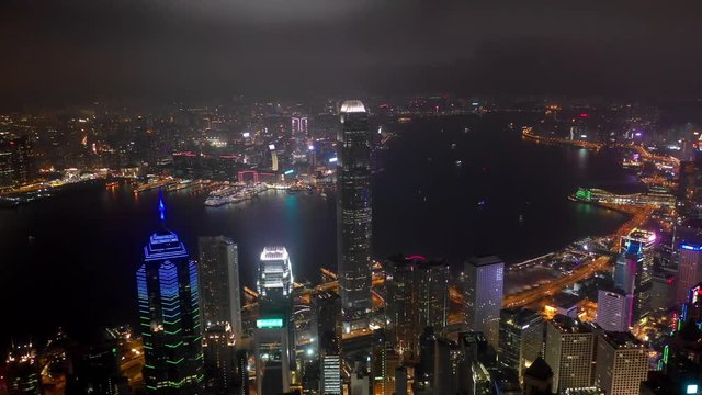 night illuminated flight over hong kong cityscape victoria harbour bay aerial panorama 4k 