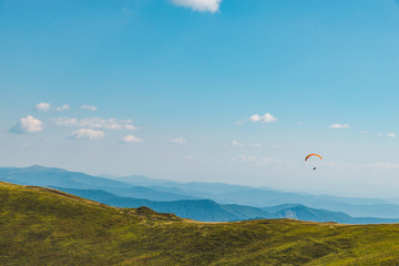 mountains leisure activities. paragliding. summer time