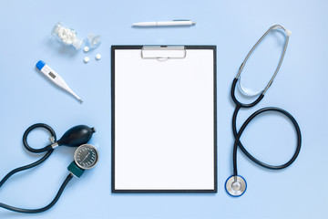 Blue medical mock-up with blank sheet of paper on the clipboard