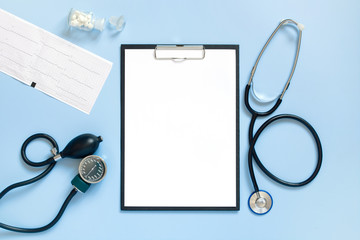 Blue medical mock-up with blank sheet of paper on the clipboard