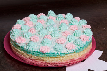 Waffle cake made from cream soaked cakes. Decorated with cream flowers.