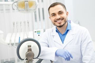 Handsome male professional dentist at his office - Powered by Adobe