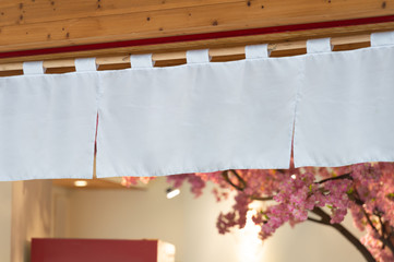 The curtain-like fabric that hangs in front of traditional Japanese restaurants and shops not only serves as a signboard, but holds a larger meaning,