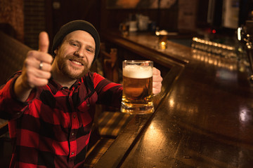 Young man relaxing at the pub having beer