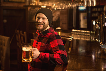 Young man relaxing at the pub having beer