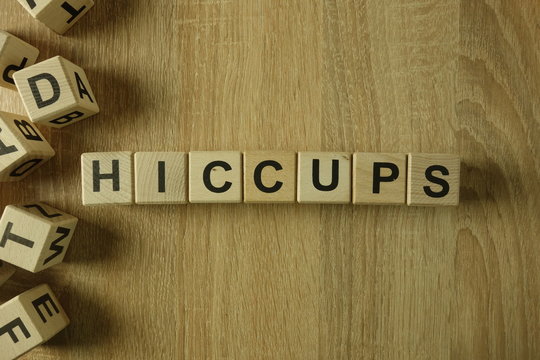 Hiccups word from wooden blocks on desk
