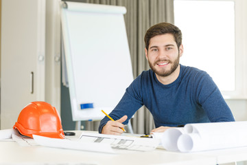 Young male architect working at his office