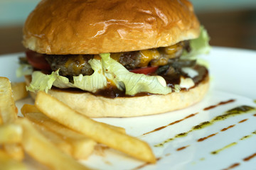 Beef burger and french fries appetizing.