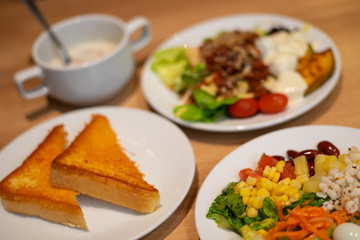 Salad in white plate on the table