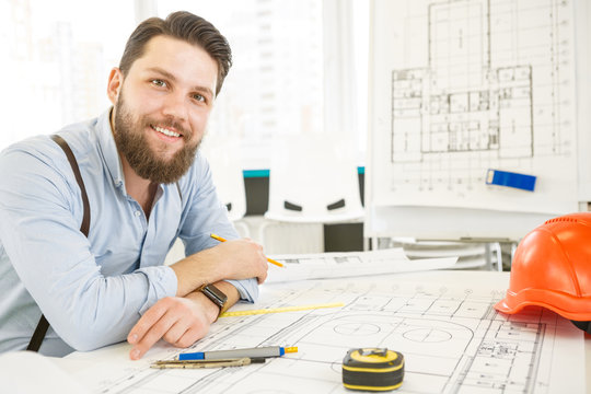 Young male architect working at his office