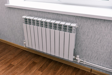 Modern radiator in the house or apartment. Household bimetallic batteries. Panel water radiator system in a residential area
