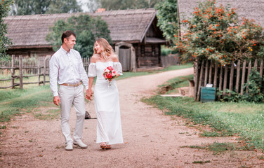 Newlyweds walk around the village on their wedding day