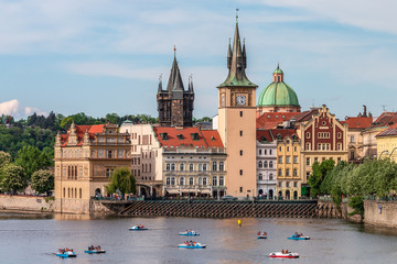 Summer Prague cityscape with touristic catamarans on Vltava river. View of Bedrich Smetana Museum,...