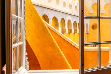 View to Pena palace yellow walls of Sintra from the window. Portugal