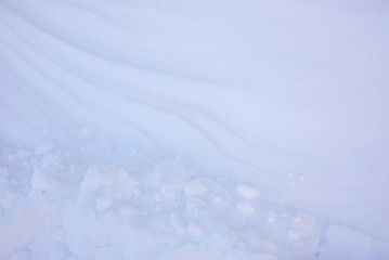 Snow and wind combined formed snow waves in a agricultural environment.