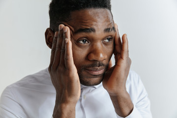 Stressed young african american man feel pain and having terrible strong headache concept. Tired...