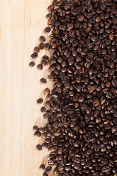 Image of fresh coffee beans on natural wooden background © JackF