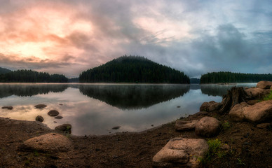 Impressively beautiful Fairy-tale mountain lake with crystal clear water Breathtaking panoramic scene during sunrise.