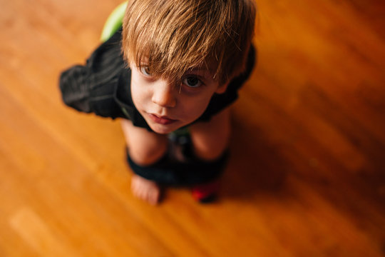 High Angle View Of Boy Sitting On Potty Chair