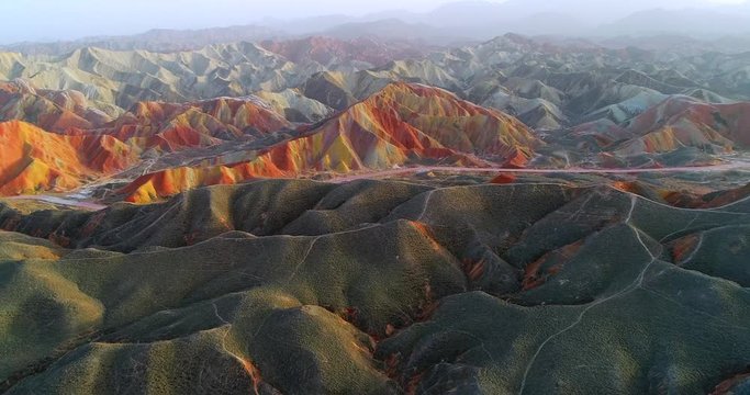 Drone flight over most colorful mountains on earth, the Rainbow mountains of Zhangye. Shown is the most vibrant, multicolored part of this amazing landscape located in Gansu, China. 