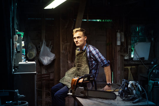 Carpenter sitting on table in workshop