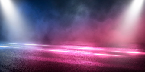 Background of the room with concrete pavement. Blue and pink neon light. Smoke, fog, wet asphalt with reflection of lights. Abstract light, searchlight rays. Night view of the street with lights, dark © MiaStendal