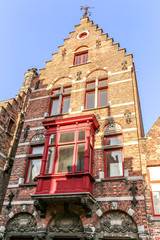 Fototapeta premium Belgium traditional brick house with red balcony in Bruges, Belgium