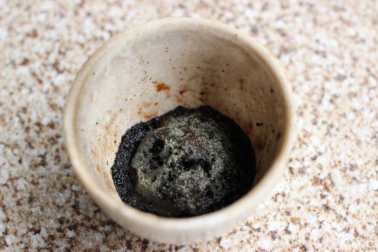 A Black Precipitate Of Manganese Oxide, Which Was Produced In A Ceramic Crucible After A Chemical Reaction Of Decomposition.