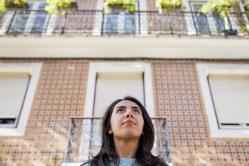 Content beautiful young woman at city building