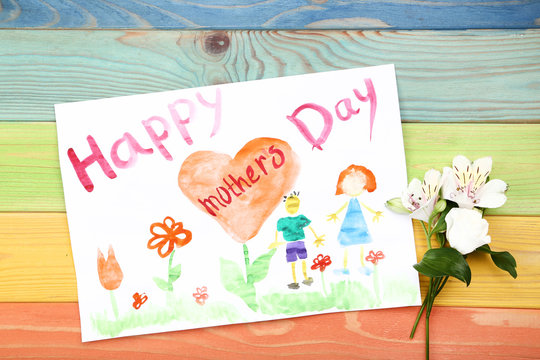 Greeting card for Happy Mothers Day with flowers on wooden table