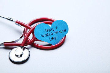 Text April 7 and World Health Day with stethoscope on grey background