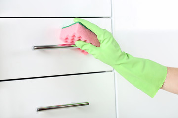 Hand in glove cleaning kitchen drawer