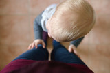 Overhead view of boy standing with mother at home