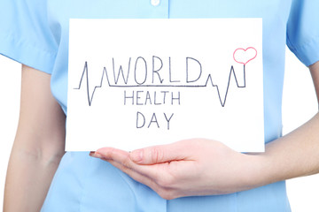 Paper with text World Health Day in female hand