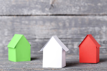 Colorful paper houses on grey wooden table